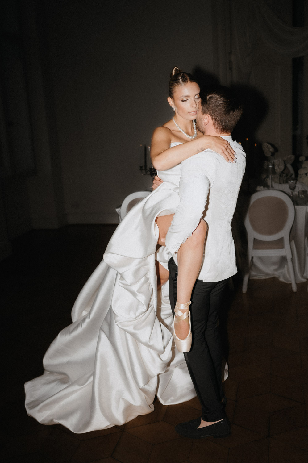 Bride being carried during the first dance in an evening reception